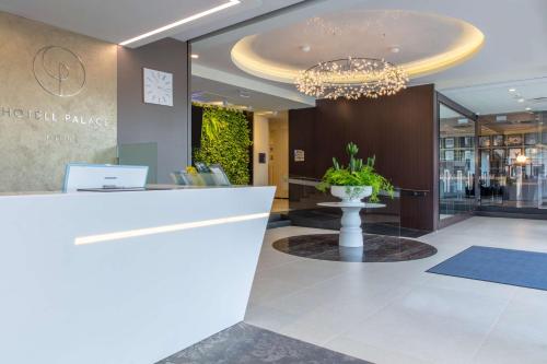 a lobby of a hotel with a chandelier at Palace Hotel Tallinn, a member of Radisson Individuals in Tallinn