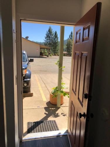 an open door with a view of a parking lot at Brownsville Motel in Brownsville