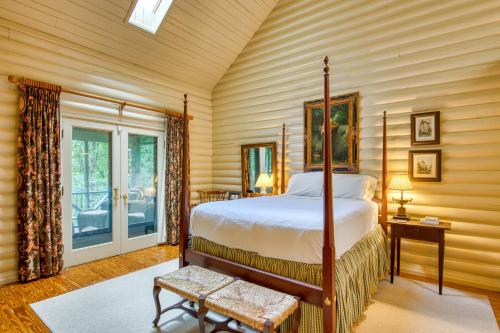 a bedroom with a bed in a room with wooden walls at Laurel Cabin in Cashiers