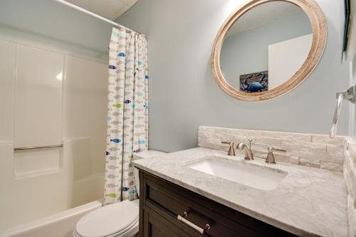 a bathroom with a sink and a toilet and a mirror at Beach side condo at Hilton Head Resort Villas in Hilton Head Island