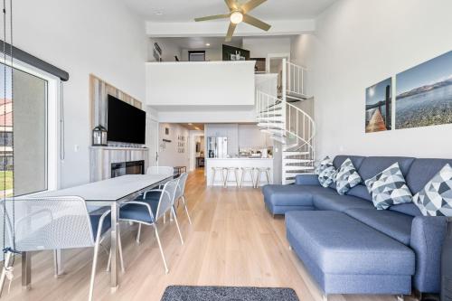 a living room with a blue couch and a table and chairs at Lake Chelan Shores II in Chelan