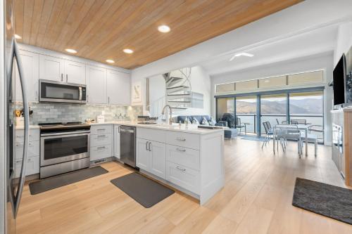 a kitchen with white cabinets and a dining room at Lake Chelan Shores II in Chelan