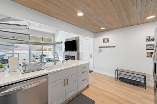 a kitchen with white cabinets and a large window at Lake Chelan Shores II in Chelan