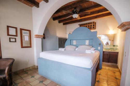 a bedroom with a blue bed in a room at HEVEN Residence in Zipolite
