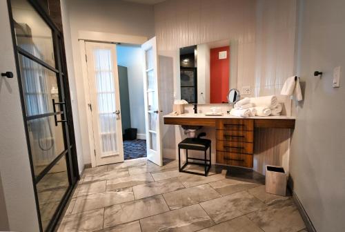 a bathroom with a sink and a counter with a mirror at Cannery Pier Hotel & Spa in Astoria, Oregon