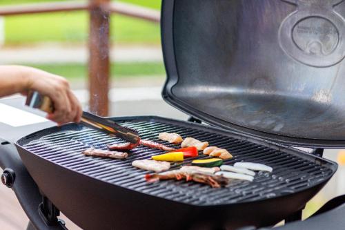 a person is cooking food on a grill at Soukyu 蒼穹 #TB1 in Yonago