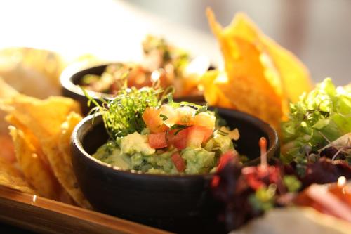 a plate of food with a bowl of salsa and chips at Hotel Sommelier Agustinas in Santiago