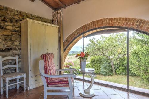 a room with a table and chairs and a window at Borgo Romena in Pratovecchio