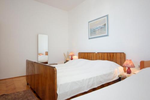 a bedroom with two beds and a mirror at Apartments by the sea Vis - 8885 in Vis