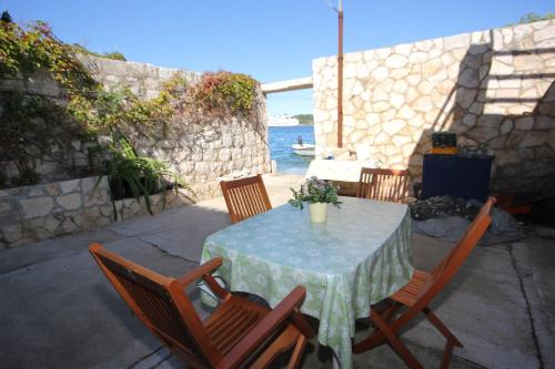 a table and chairs with a table and the ocean at Apartments by the sea Vis - 8885 in Vis