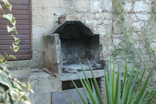 a brick oven sitting on the side of a building at Seaside holiday house Vis - 8902 in Vis