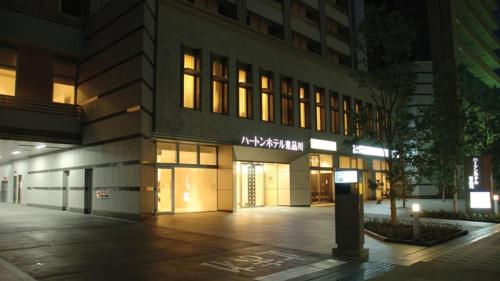 a building with a sign on the side of it at Hearton Hotel Higashi-Shinagawa in Tokyo