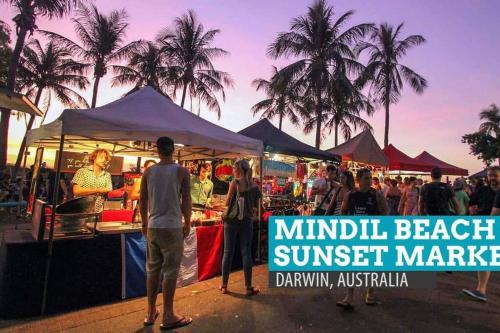 a group of people standing in front of a market at ZEN CITY Modern 1-BR City Apt Near Mindal Markets in Larrakeyah