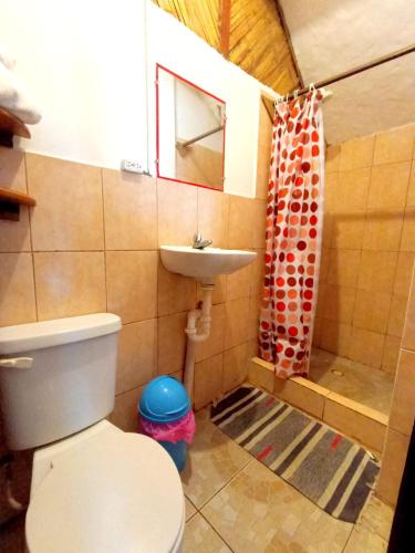 a small bathroom with a toilet and a sink at Hostal Mirada al Mar in Las Tunas