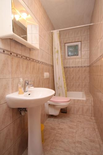 a bathroom with a sink and a toilet at Apartments by the sea Ivan Dolac, Hvar - 8782 in Ivan Dolac