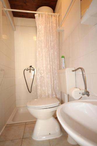 a bathroom with a white toilet and a sink at Apartments by the sea Rukavac, Vis - 1154 in Vis