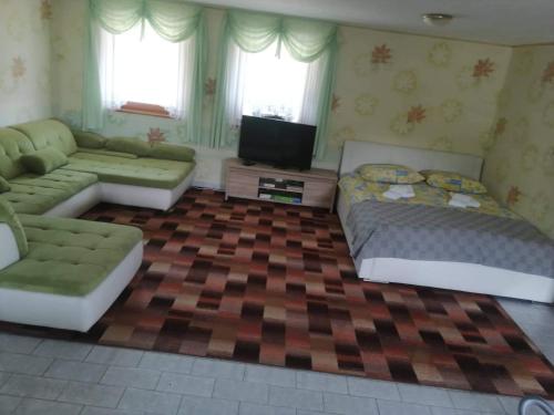 a living room with two beds and a couch at Apartma Gorca Plevnik in Buče