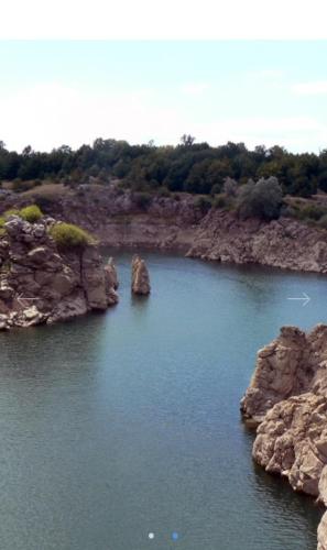 a large body of water with some rocks in it at Apartman Šoljac in Perušić