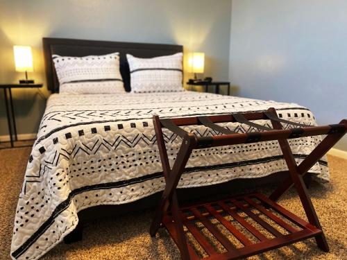 a bedroom with a large bed with a wooden frame at New Family Friendly Stay! No Checkout Work! in College Station