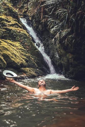 a man is in the water with a frisbee at Villa Celina: La cabañita de Guadua in Santa Elena