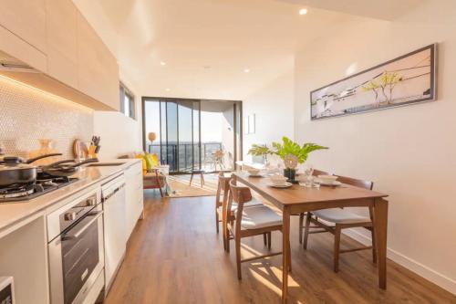 a kitchen with a wooden table and a dining room at AirTrip Apartments at South Brisbane in Brisbane