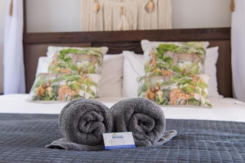 a bed with towel towels on top of a bed at Ocean View Apartment 49 in Airlie Beach