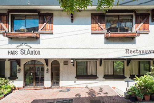 a building with windows and a sign that reads hrs salion at Hotel Haus St Anton in Nozawa Onsen