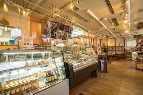 a bakery with a display case in a store at Hotel Haus St Anton in Nozawa Onsen