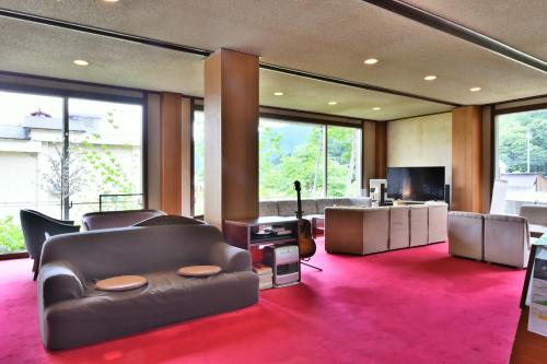 a large living room with a couch and a television at Arya Hotel Alpin Route / Vacation STAY 8237 in Omachi