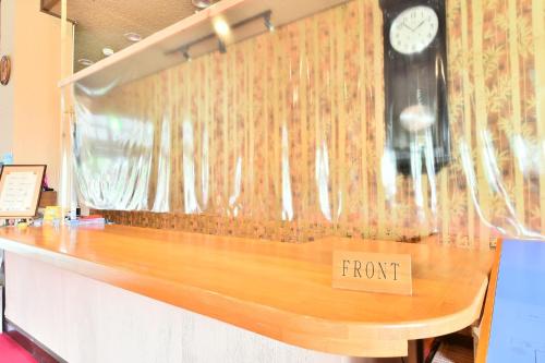 a wooden counter top with a sign that reads front at Arya Hotel Alpin Route / Vacation STAY 8237 in Omachi