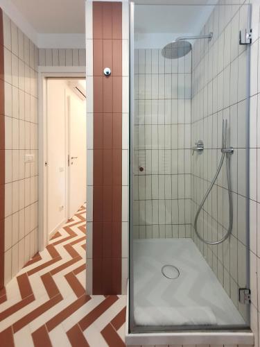 a bathroom with a shower with a glass door at La Casa di Mina in Monte di Procida