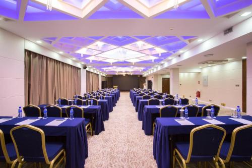 a banquet hall with blue tables and chairs at Kempinski Hotel Khan Palace in Ulaanbaatar