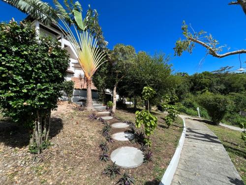 a path in a garden with trees and rocks at KohTao Studios Sunset in Koh Tao