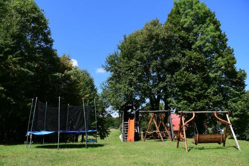 a park with two swings and a playground at Deluxe Apartments Franjkovic in Seliste Dreznicko
