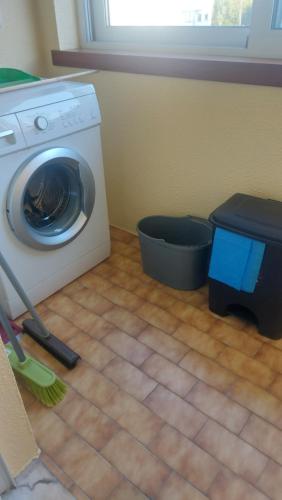 a washing machine sitting in a kitchen with a broom at Vila Maria in Vila Praia de Âncora