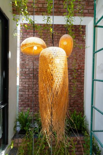 three wicker vases are hanging from a building at Hoianese Center Hotel - Truly Hoi An in Hoi An