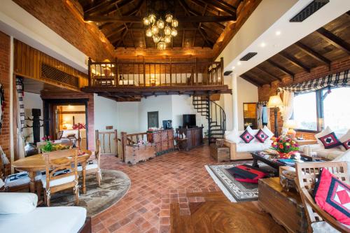 a living room filled with furniture and a wooden ceiling at The Dwarika's Hotel in Kathmandu