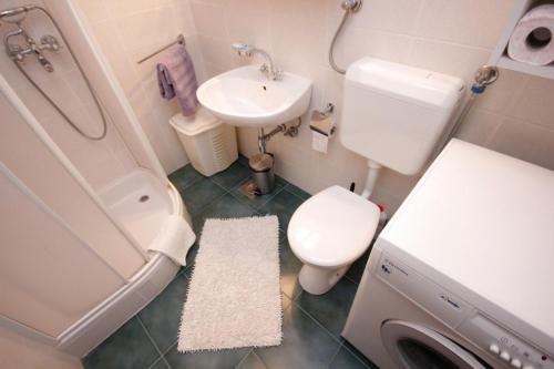 een kleine badkamer met een toilet en een wastafel bij Apartments by the sea Vis - 8875 in Vis