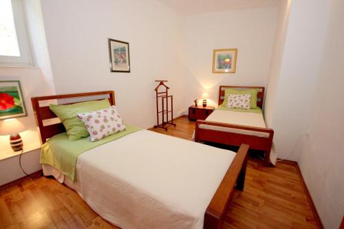 a bedroom with two beds and a table with lamps at Apartments by the sea Vis - 8932 in Vis