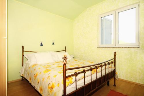 ein Schlafzimmer mit einem Bett und einem Fenster in der Unterkunft Apartments with parking spaces Brgujac, Vis - 8919 in Rukavac
