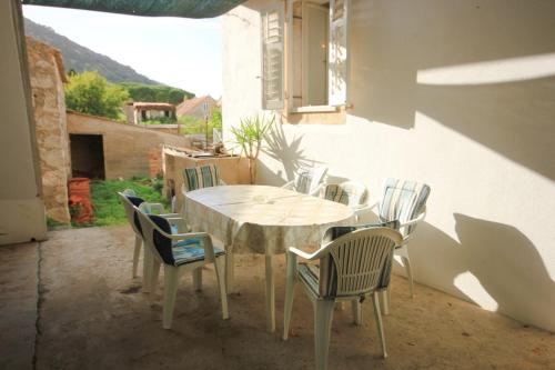 a white table and chairs in a patio at Seaside holiday house Vis - 8907 in Vis