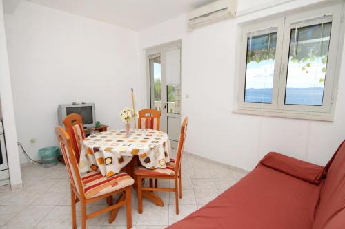 a dining room with a table and chairs at Apartments by the sea Brna - Vinacac, Korcula - 9152 in Smokvica