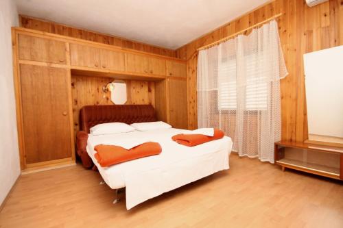 a bedroom with a white bed and a window at Apartments by the sea Brna, Korcula - 9149 in Smokvica