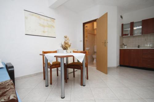a kitchen and dining room with a table and chairs at Apartments by the sea Brna, Korcula - 9149 in Smokvica