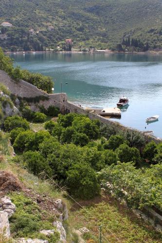 a view of a lake with a boat in the water at Rooms by the sea Zaton Mali (Dubrovnik) - 8997 in Zaton