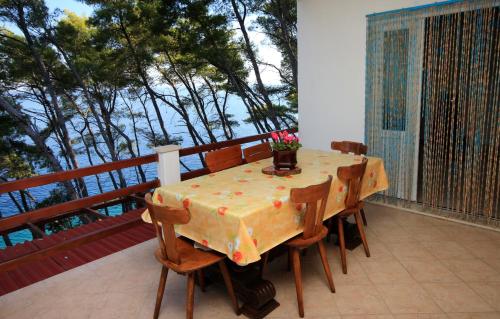 a table on a balcony with a view of the ocean at Secluded fisherman's cottage Cove Spiliska, Korcula - 9142 in Vela Luka