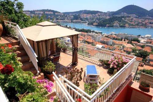 a balcony with a gazebo and flowers at Apartments with WiFi Dubrovnik - 8975 in Dubrovnik