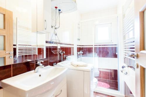 een witte badkamer met een wastafel en een spiegel bij Apartments by the sea Brna, Korcula - 9147 in Brna