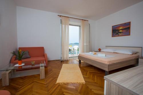 a living room with a bed and a couch at Apartments with a parking space Brsecine, Dubrovnik - 9098 in Brsečine