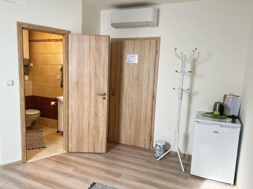a bathroom with a toilet and a wooden door at Ubytování nad sklípkem v Šatově in Šatov